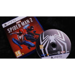 Close-up of a Spider-Man 2 PlayStation 5 game case with Marvel branding and a disc resting beside it on a dark surface