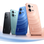 Five smartphones in black, teal, blue, pink, and rose gold angled diagonally, showing rear triple-camera modules.